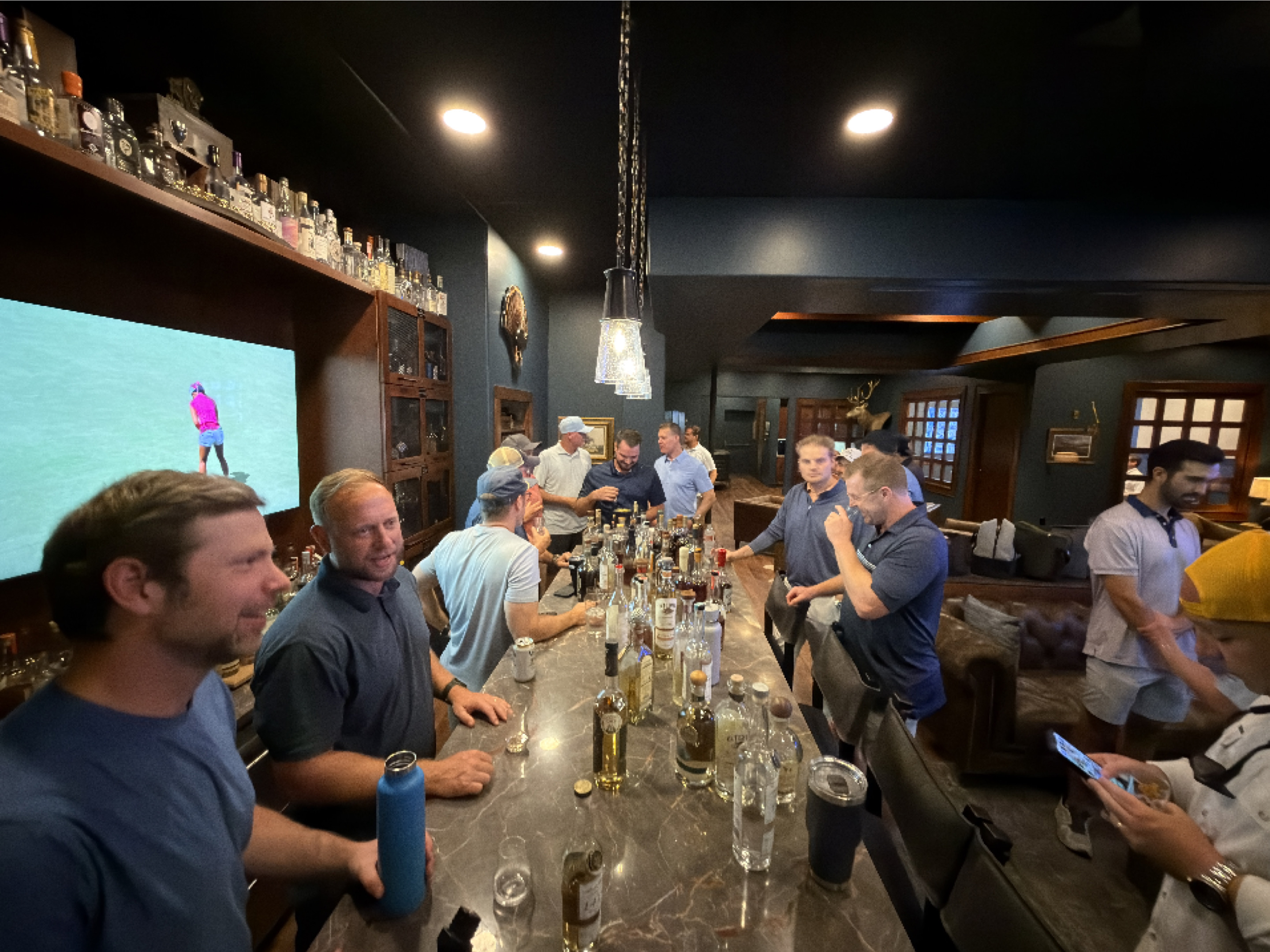 Full Proof Society members gathered around the home bar