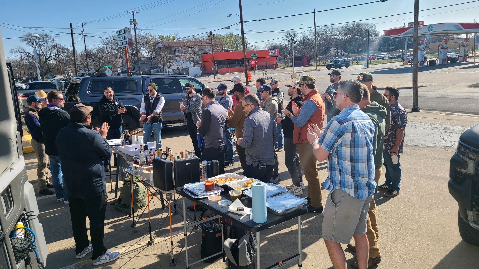 Members gathered and cheering at an outdoor tailgate tasting