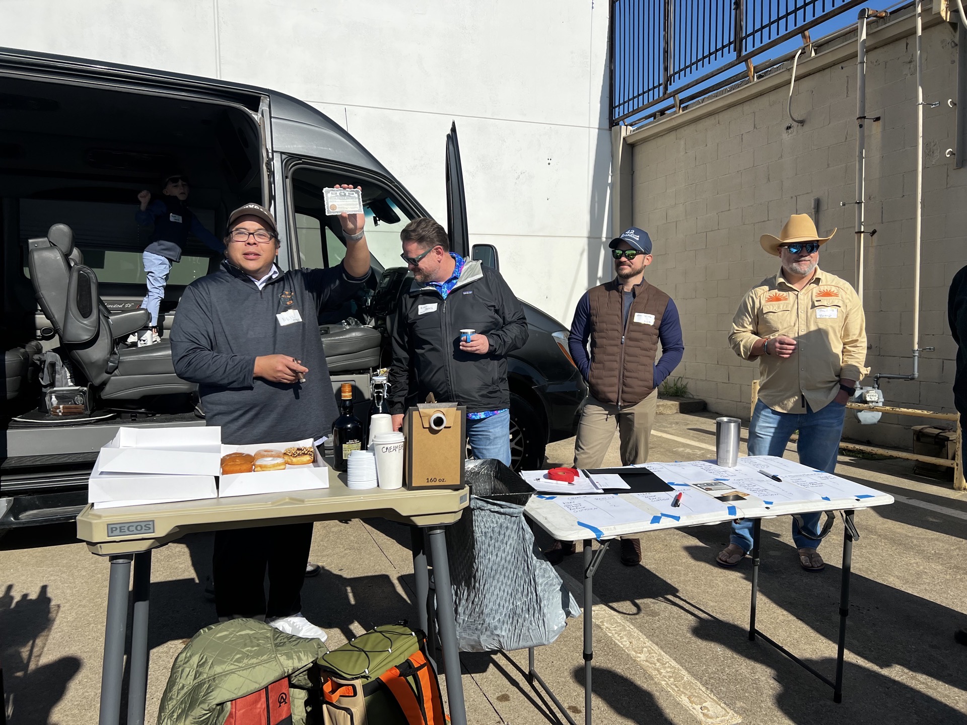 Members at a Full Proof Society tailgate and charity gathering